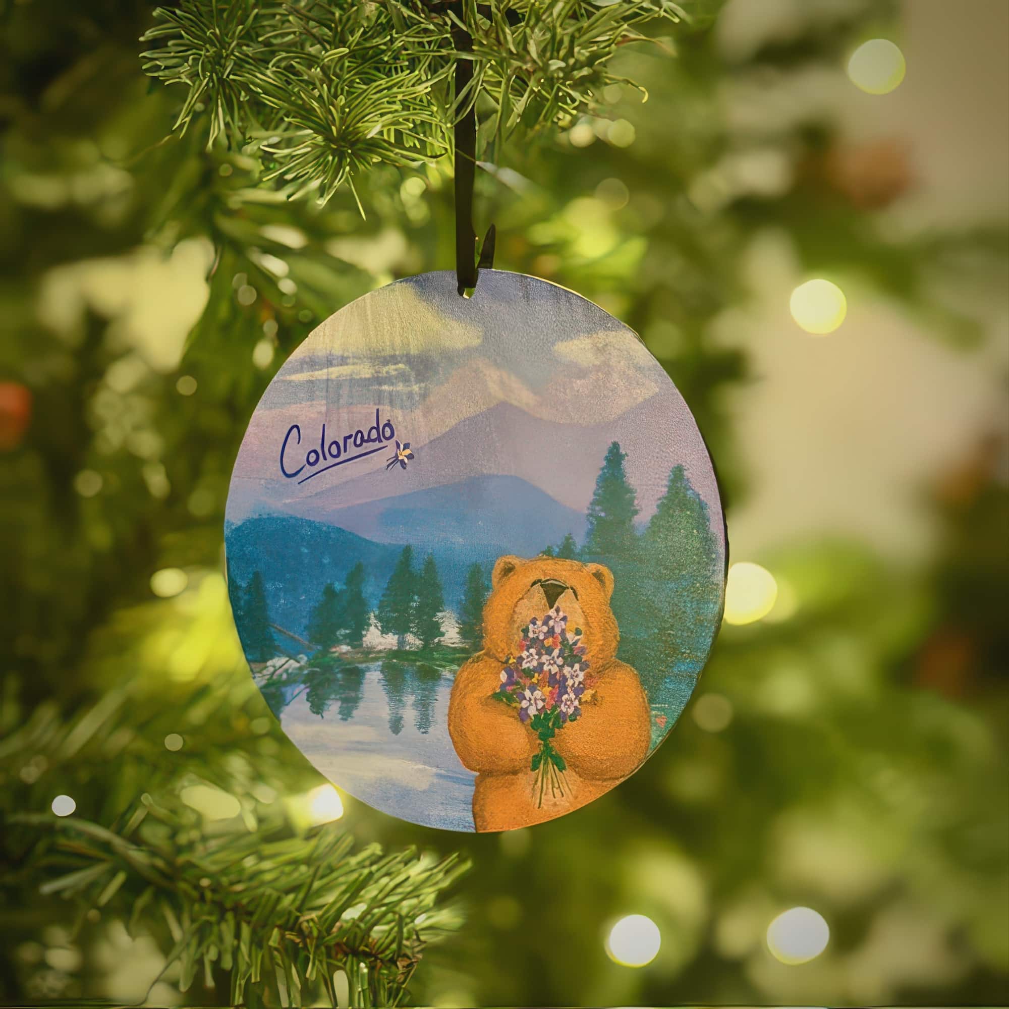 Colorado Bear ornament by Colorado artist Cindy DeWolfe, a brown bear holding columbine flowers